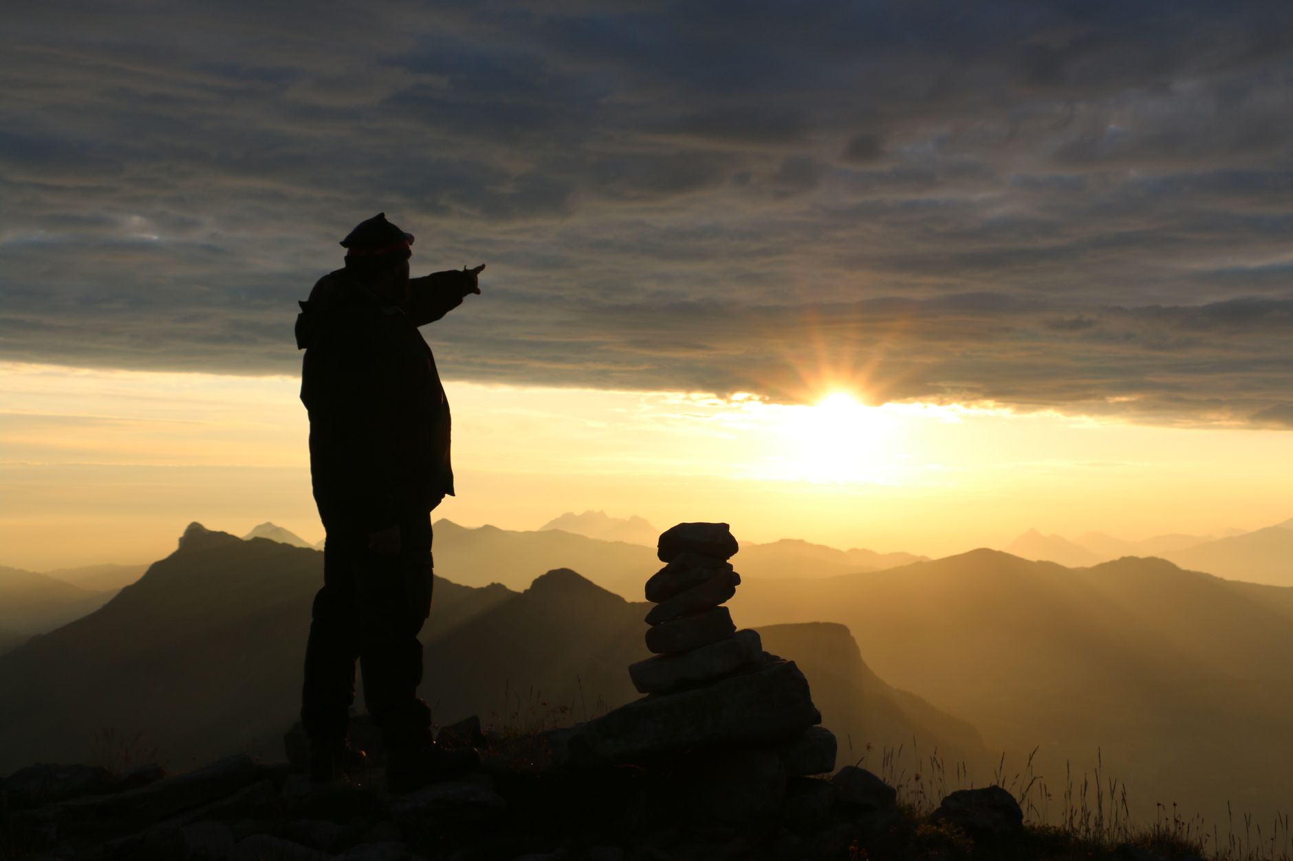 Traveler looking out toward mountain range during golden hour
