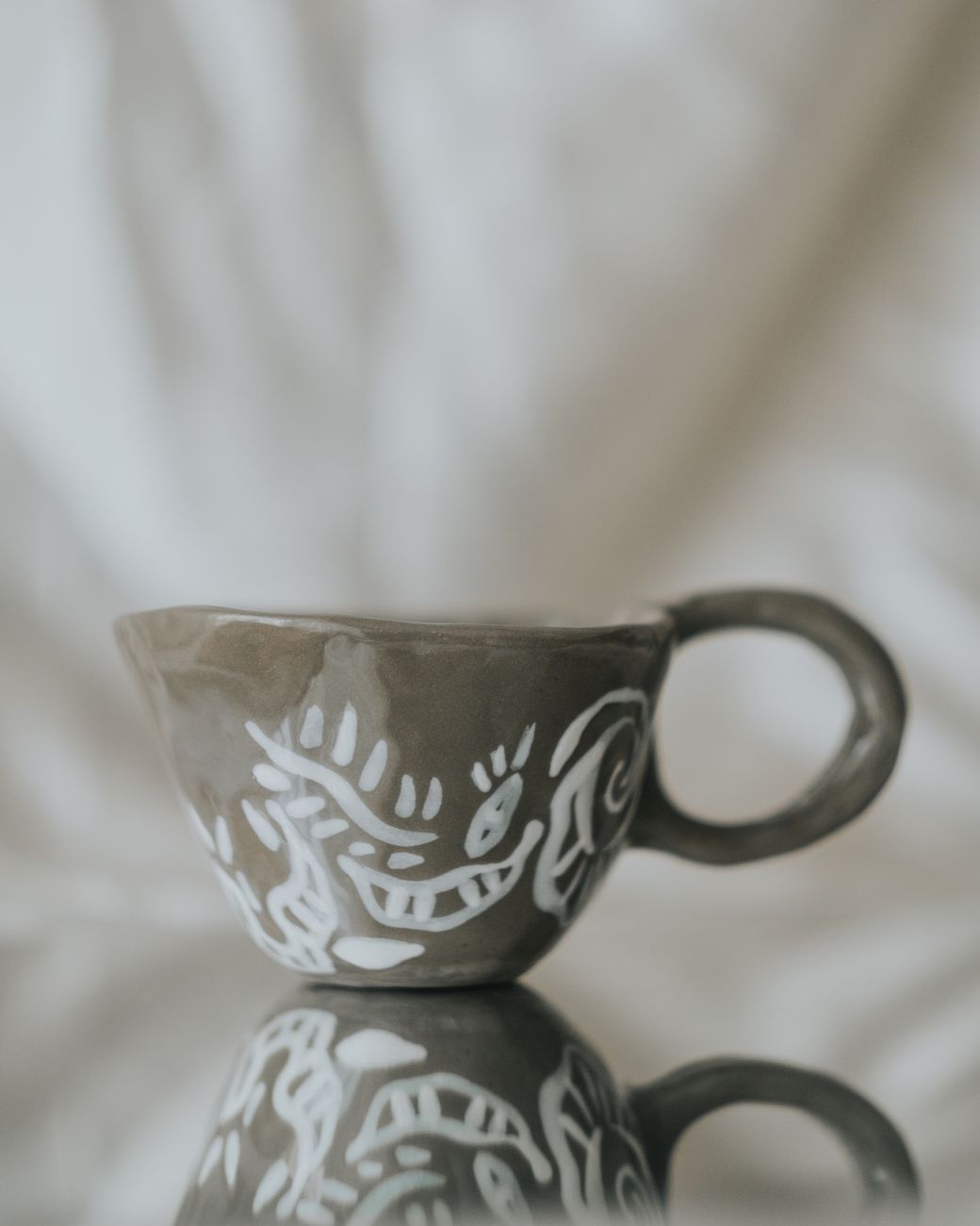 Handcrafted tea bowl and minimalist stone interior
